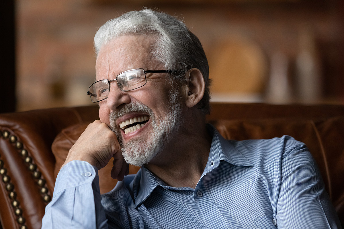 Older man smiling with restored teeth