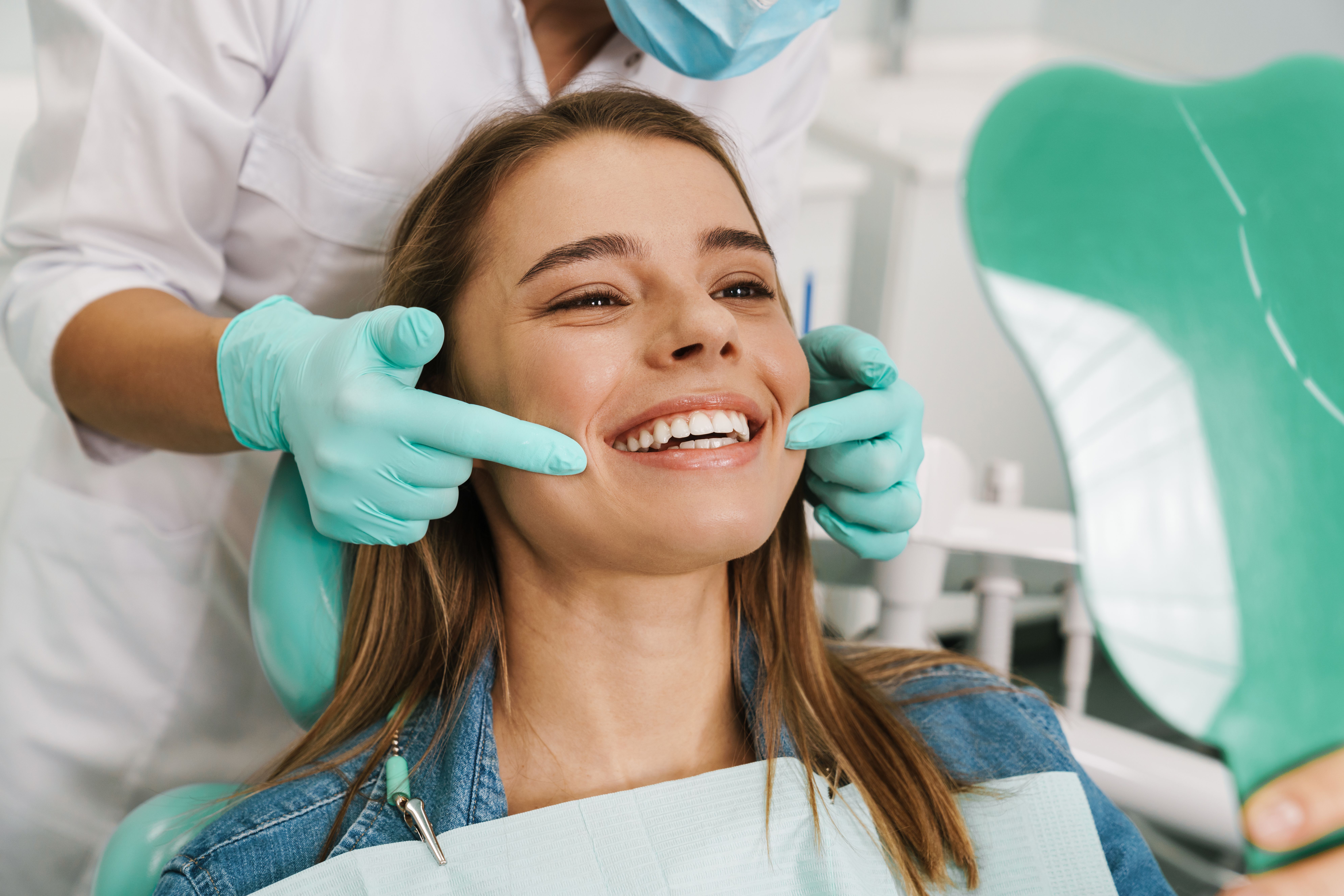 Dental patient viewing her smile in a mirror