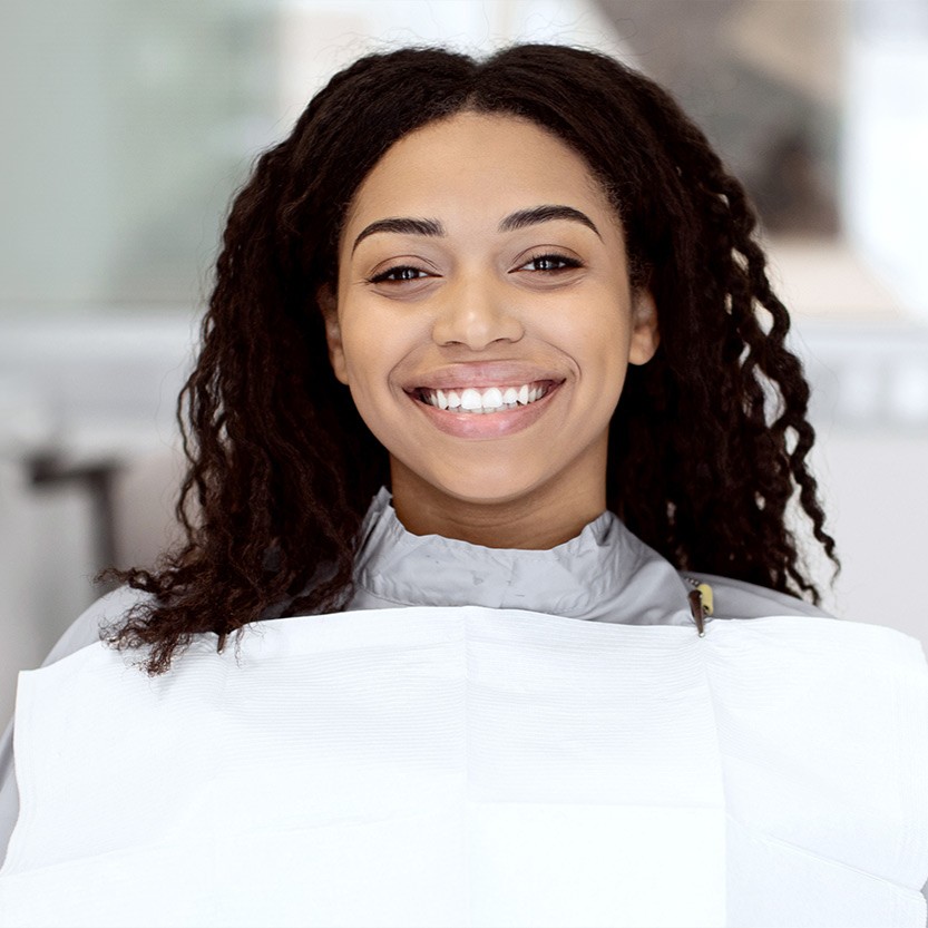 Dental patient smiling after teeth whitening
